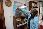 SuAnn Reddick points to locations on a historic map of the Chemawa Indian School campus.