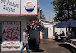 Signs in support of firefighters hang at Sno Cap Drive In as diners sit down in Sisters.