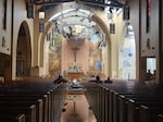 Salem firefighters sit inside St. Joseph Parish in Salem, Ore., where a fire destroyed a portion of the roof and heavily damaged the church in the early morning of August. 31, 2023. The five-alarm fire was caused by arson.