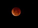 A blood moon is seen during a lunar eclipse on Nov. 8, 2022, over Brisbane, Australia. 