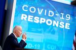 Pres. Biden speaks in front of a screen that says "COVID-19 Response."