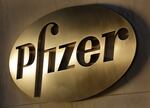 In this Monday, Nov. 23, 2015, file photo, the Pfizer logo is displayed at world headquarters in New York. On Monday, Nov. 9, 2020, Pfizer said an early peek at its vaccine data suggests the shots may be 90% effective at preventing COVID-19.