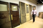 Brandon Foy walks past the old doors he found in the building he's renovating in downtown Pendleton.