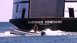 A man navigates the wake behind the Martha's Vineyard Ferry on Monday in Vineyard Haven, Mass.