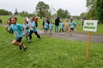 Elementary students walk and jog through Bush's Pasture Park for the annual Awesome 3000 youth fun run in Salem, Ore., on April 27, 2024.