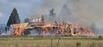 A family barn at Coleman Ranch in Molalla, Ore., is burned by a fourth-alarm fire on June 18, 2026.