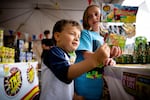 Sophie (right) and Zach Plummer-McGraw look at fireworks at the TNT Fireworks stand in Beaverton, Ore., Wednesday, July 3, 2019.