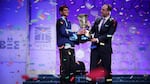 Karthik Nemmani (L) poses with the championship trophy and E.W. Scripps Company CEO Adam Symson after Nemmani correctly spelled the word 'koinonia' to win the 91st Scripps National Spelling Bee at the Gaylord National Resort and Convention Center May 31, 2018 in National Harbor, Maryland.