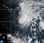 This NOAA satellite image taken Saturday, Aug. 22, 2026, shows Tropical Storm Moke advancing towards Hawaii in the Pacific Ocean.
