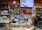 Ceramics artist and educator John Hasegawa demonstrates how to create a ceramic plate using cameras and a big screen TV in his classroom at Mt. Hood Community College.