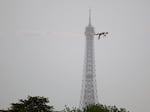 Tightrope walker Nathan Paulin performs on a high rope during the athletes parade on the River Seine near the Supreme Court during the opening ceremony of the Olympic Games Paris 2024 on July 26, 2024 in Paris, France.