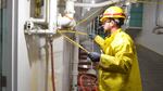 A worker repairs the electrical system following a malfunction at the West Point Wastewater Treatment Plant.