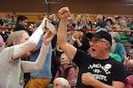 People chant "fight back" at the town hall.