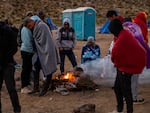 Migrants huddling for warmth at an unofficial detention camp in Jacumba, California. A record number of people have arrived at the US southern border in the last year.