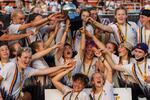 Members of the South Eugene Gender Diverse Ultimate Frisbee Team host their trophy after winning the high school national championships in Richmond, Virginia on Sunday, June 12, 2022.