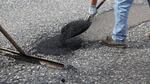 An ODOT maintenance crew fills potholes on Highway 26.