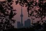 Smoke from forest fires in Northern Ontario and in Quebec contribute to pink hazy sunset in the city from the Cherry Beach over Toronto on June 6, 2023.