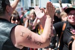 A woman's arm reads "I am not afraid" as she gives high-fives to participants in the Portland Pride Parade Sunday, June 19, 2016. The Sunday prior to Portland's parade a gunman opened fire at a gay nightclub in Orlando, Florida, killing 49 members of the LGBT community.