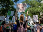 Texas abortion rights supporters march near the Austin Convention Center in May of 2022. A new lawsuit filed in state court asks a judge to clarify medical exemptions in the state's abortion bans.