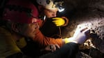 Caver Neil Marchington (right) sucks up spiders, millipedes, and other insects with a tube, before blowing them into a collection vial. This is science in action (and don't worry: there's a screen in the tube that only a few critters have managed to slip past).