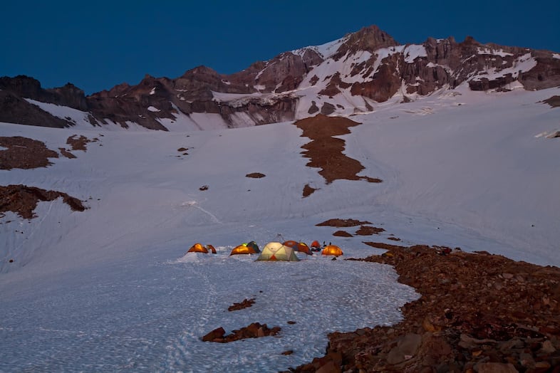 "Kamp Tenacious" was the name given to the rocky, exposed and often uncomfortable patch of glacier at 6,400 feet in elevation that served as base camp. It had the benefit of providing excellent access to the three named glacier caves; Snow Dragon, Pure Imagination and Frozen Minotaur. Each year, teams of specialists would spend up to a week based at Kamp Tenacious to map, survey and conduct science within the unique glacier cave ecosystem. Lead explorers Brent McGregor, Eduardo "Eddy" Cartaya and Scott Linn made more frequent visits to keep tabs on seasonal changes to the caves.