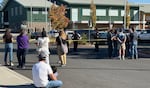 People wait outside of Silver Rail Elementary School, in Bend, Ore., Oct. 15, 2026. A shooting occurred at the school, leaving multiple victims, including children, officials say.
