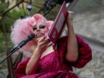 Drag Queen Brigitte Bandit reads a book during a story time reading at the Cheer Up Charlies dive bar on March 11, 2023 in Austin, Texas. Bills to restrict drag performances across the country have failed to make an impact.