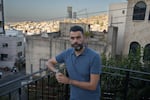 Ahmad Khalefa, 42, a human rights lawyer, poses for a portrait outside his home in Umm al-Fahm, Israel on Sept. 12. A Palestinian citizen of Israel, Khalefa was arrested for chanting anti-war slogans at a demonstration, was charged with incitement of terrorism and spent four months in Israeli prison. He is now under partial house arrest.