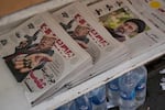 FILE — Iranian newspapers displayed at a newsstand feature a caricature of U.S. President Donald Trump and a portrait of Iran's Supreme Leader Ayatollah Mojtaba Khamenei. Headlines in Farsi include "The destruction of the U.S. missile shield" and "Why the U.S. surrendered," in Tehran, Iran, Monday, July 27, 2026.