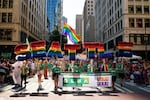 FILE - Marchers with the Greater Seattle Business Association, Washington State's LGBTQ+ and allied chamber of commerce, hold rainbow letters spelling out "Seattle," during the annual Seattle Pride Parade, June 25, 2023, in Seattle.