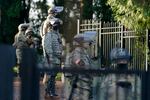 Members of the Washington National Guard stand along a perimeter fence at the Governor's Mansion, Sunday, Jan. 10, 2021, at the Capitol in Olympia, Wash. Washington Gov. Jay Inslee activated members of the National Guard this week to work with the Washington State Patrol to protect the Capitol campus ahead of the state Legislature opening its 2021 legislative session Monday, as several protests and rallies are expected.