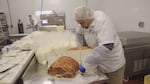 Owner Francisco Ochoa prepares queso cotija enchilado. The cheese has a chili wash on the outside.