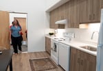 People tour one of the staged units at the new building.