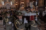 Ukrainian military members carry the coffin of Oleksiy Yukov, head of the Ukrainian platsdarm search unit, during his funeral at the St. Volodymyr's Cathedral in Kyiv on August 8, 2026, amid the Russian invasion of Ukraine. For years, Oleksiy Yukov walked the boundary between the living and the dead as he led a group of volunteers retrieving corpses in the most dangerous parts of Ukraine's front. He was killed on August 5, 2026 during what would be his last search mission, the news of his death triggering an outpour of grief, especially in the eastern Ukraine, where he had become a familiar figure, often appearing in the moments of grief that have come to define life the Donetsk region, battered by years of Russian assaults.