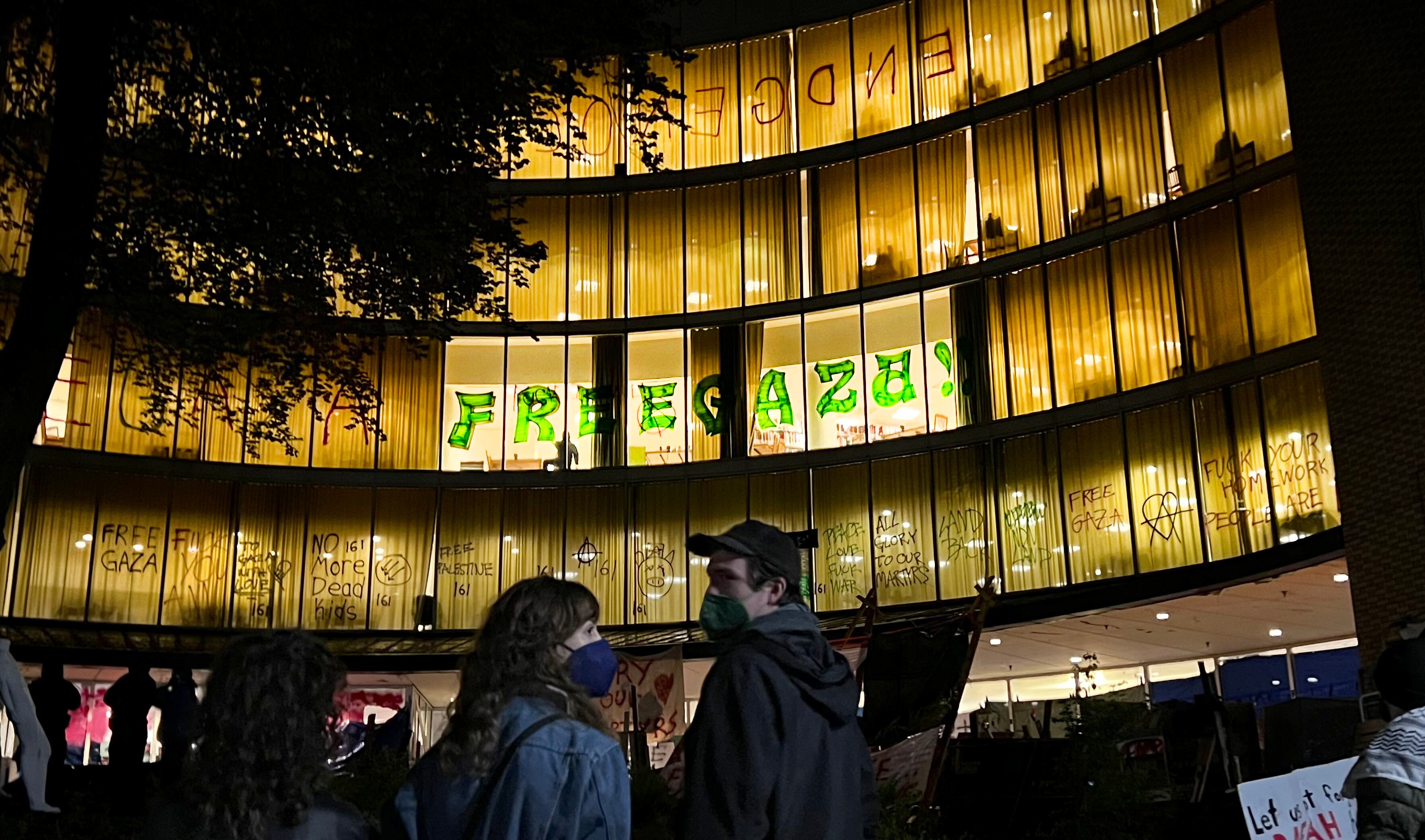 A small crowd stands outside the occupied Branford Price Millar Library at Portland State University, where an open mic event was held Tuesday evening.