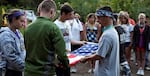 In this undated photo provided by Oregon Summer Star, campers fold a flag in honor of those who serve in the military. A new bill would support the camp, which supports children from military families. The camp has recently faced financial struggles.