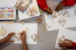 Students paint ornaments for The Grotto's Festival of Lights.