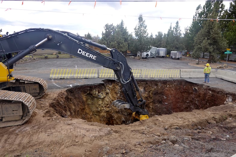 Workers in Redmond, Ore., use heavy machinery to build a new sewer line on the city's west side. Redmond's population has grown by an estimated 25% since 2015, and city planners expect the trend to continue.