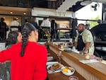 Chef Jonathan Biko Mandela Jones chats with patrons during a preview night for BIRDFAT, a pop-up event he and Henderson Ave. founder Tiquette Bramlett created to celebrate jazz, food and community.