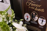 Flowers and remembrances are displayed for the six athletes, coaches and family members who perished in a plane crash, at The Skating Club of Boston in Norwood, Mass., on March 25, 2025. A plaque that reads "Forever in our hearts" displays photos of figure skaters Spencer Lane and Jinna Han along with coaches Evgenia Shishkova and Vadim Naumov. Parents Christine Lane and Jin Han are also named.