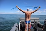 British South African endurance swimmer Lewis Pugh stretches before entering the water to complete his 12-day 62-mile swim around the island of Martha's Vineyard, Mass., ahead of the 50th anniversary of the first blockbuster film "Jaws"' release on Monday.