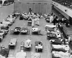 Make-shift hospitals were set up in Portland, and other cities.  Here volunteer nurses from the American Red Cross tend influenza sufferers in the Oakland Auditorium, in California.