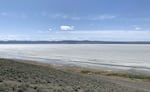A mostly dry section of Lake Abert in south central Oregon on a mostly blue sky day.