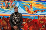 Arvie Smith poses in front of a mural he created with the residents of the Donald E. Long Juvenile Detention Center.