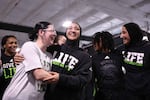 Zaynah McBryde (center) and sister Jamilah (right) celebrate with teammates after finding out that USA wrestling would let them compete in trials.