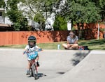 (Left to right) Gabriel Mitchell-Castro, 3, rides his bike around Happy Valley Park’s skate park while his mother, Natasha Castro cheers him on in Happy Valley, Ore., July 9, 2025. A recent study has pointed to these outdoor recreation spaces as a necessity during crises like the COVID-19 pandemic.