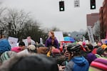 A girl peers above the crowd at Women's March on Portland Saturday, Jan. 21, 2017.