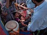 Children reach for food handouts in the aftermath of the catastrophic flooding in Pakistan, which has destroyed rice, corn and wheat crops and left over a third of the country under water.