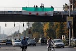 Syrians wave the Syrian opposition flag as they celebrate the ouster of former leader Bashar al-Assad in Damascus. Assad and his father, Hafez al-Assad, combined to rule Syria for more than 50 years.