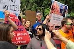 A small group of anti-abortion activists rallies on May 21, 2019, in Portland, Ore. The group held their demonstration as thousands of people also gathered in the Oregon city to protest recent abortion bans in eight states.